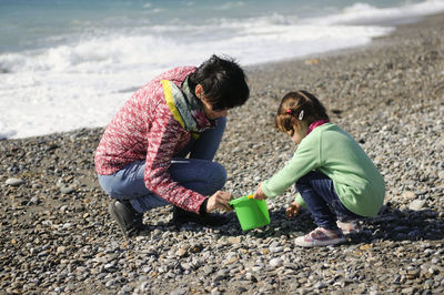 Mother and daughter playing at beach