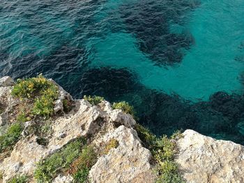 High angle view of rocks in sea