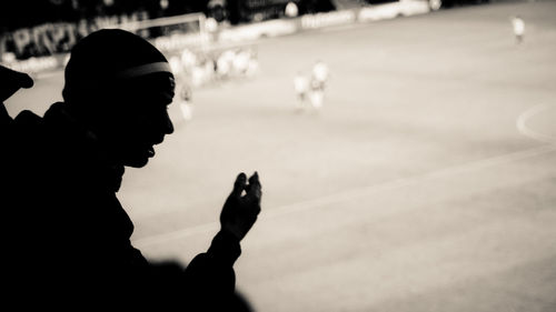 Silhouette man at soccer stadium