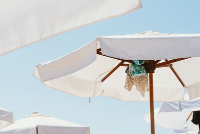 Low angle view of clothes drying on roof against sky