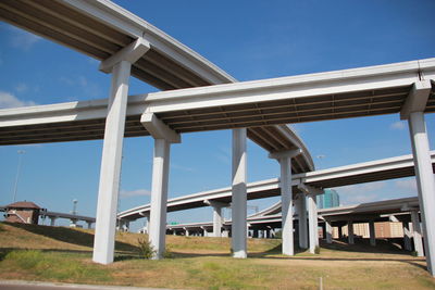 Low angle view of bridges against clear blue sky