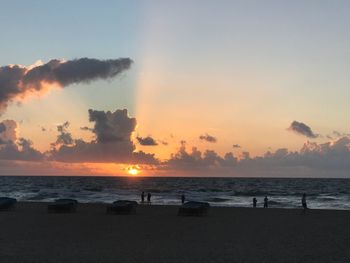 Scenic view of beach against sky during sunset