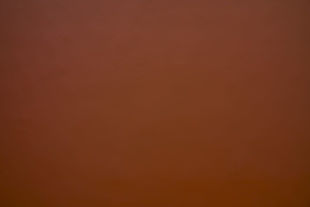 FULL FRAME SHOT OF ORANGE WALL WITH RED BACKGROUND