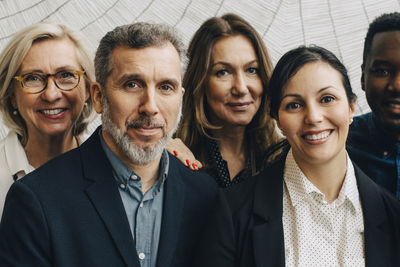 Portrait of confident male and female entrepreneurs at conference