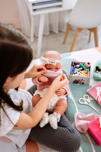Rear view of girl sitting with toys