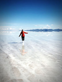 Rear view of man standing in water