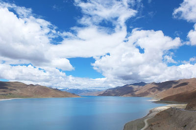 Scenic view of mountains against cloudy sky