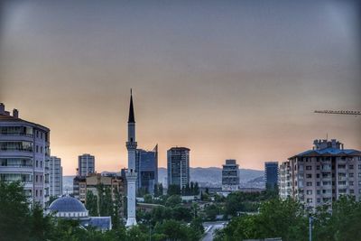 Buildings in city at sunset