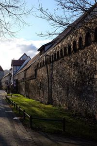 Footpath by building against sky