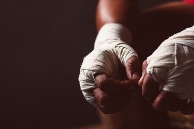 Cropped image of man with bandage tied on hands