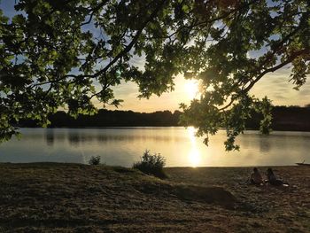 Scenic view of lake against sky during sunset