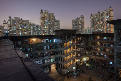 High angle view of illuminated buildings in city at night