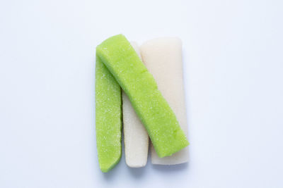 Close-up of multi colored candies against white background