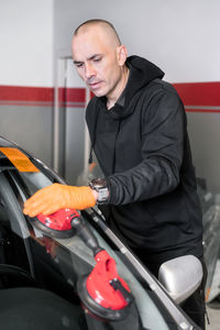 Young man holding a car