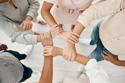 Low section of couple holding hands