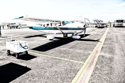 Airplane on airport runway against sky