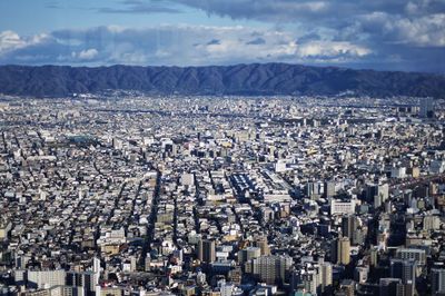 High angle view of city against cloudy sky