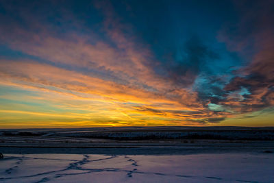 Scenic view of land against sky during sunset