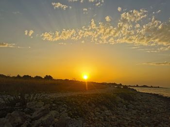 Scenic view of field against sky during sunset
