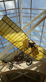 Low angle view of yellow wheel against sky