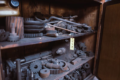 Old machine parts on shelves in industry