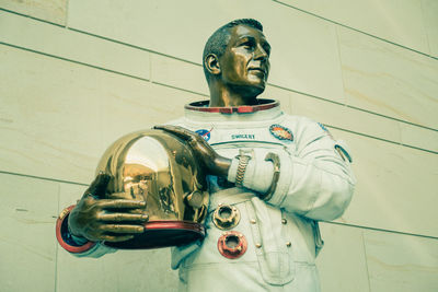 Low angle view of statue against wall