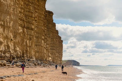 People on beach against sky