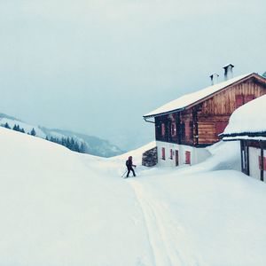 People skiing on snowcapped mountain against sky