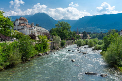 Scenic view of sea by buildings against sky