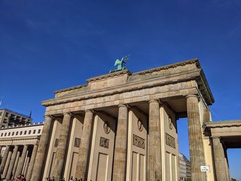 Low angle view of historical building against blue sky