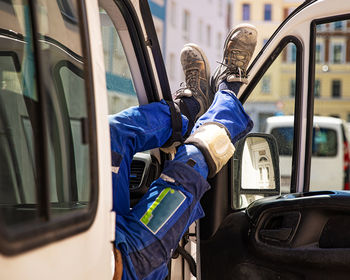 Midsection of man sitting in car