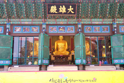 View of buddha statue in temple outside building