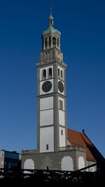 Low angle view of clock tower against blue sky