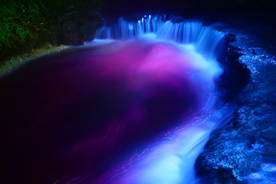 Aerial view of illuminated waterfall at night