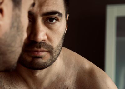 Close-up portrait of shirtless man