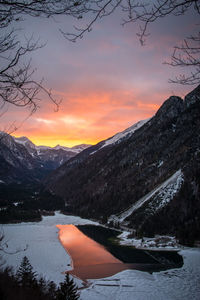 Scenic view of snowcapped mountains against sky during sunset