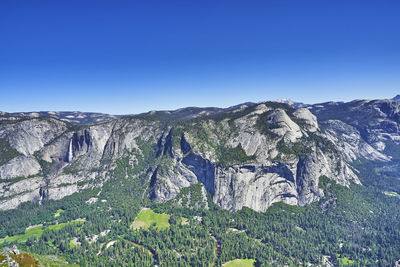 Scenic view of mountains against clear blue sky