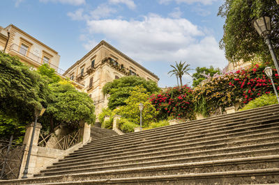 The beautiful staircase with many plants and colorful flowers leads to the cathedral of s. giorgio 