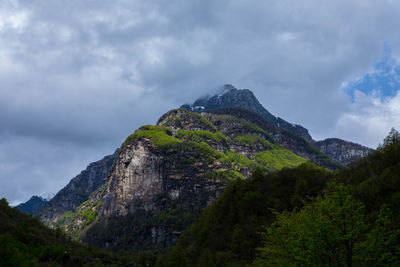 Low angle view of rocky mountain against sky