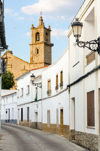 Street by church against sky in city