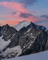 Scenic view of snowcapped mountains against sky during sunset