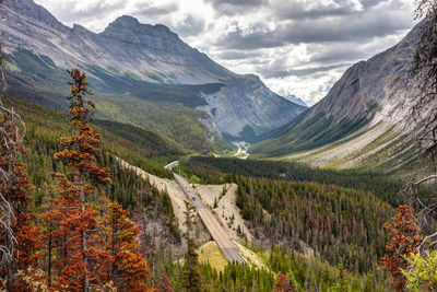 Scenic view of valley and mountains against sky