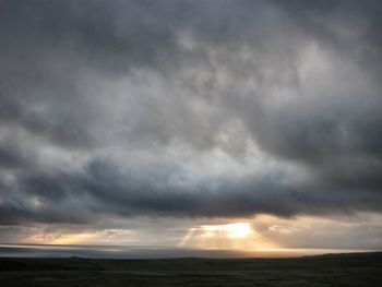 Scenic view of landscape against cloudy sky