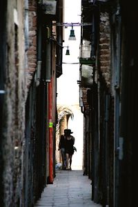 Full length of woman walking on alley