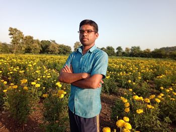 Man standing on marigold field