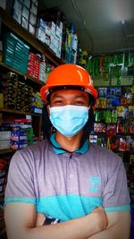 Portrait of man wearing hat standing at store