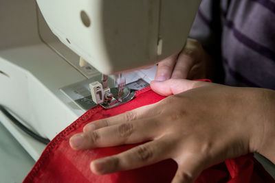 High angle view of person working on sewing machine