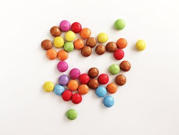 High angle view of colorful candies against white background