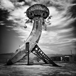 Low angle view of old ferris wheel against sky