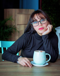 Portrait of woman with coffee cup